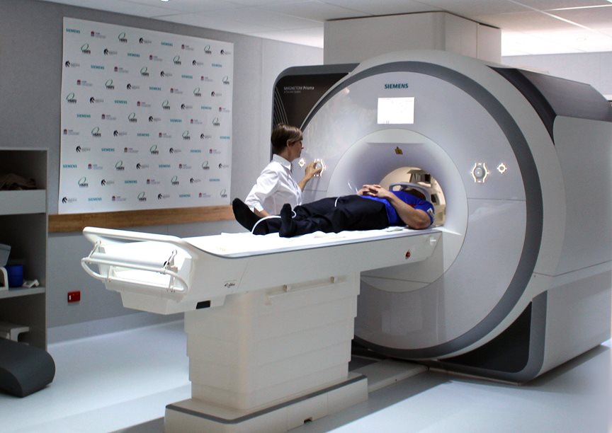 A person goes through an MRI machine