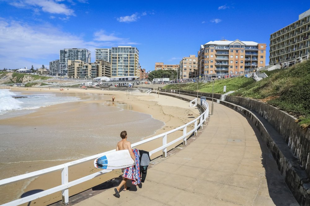 A man walking along the Bathers Way path in Newcastle