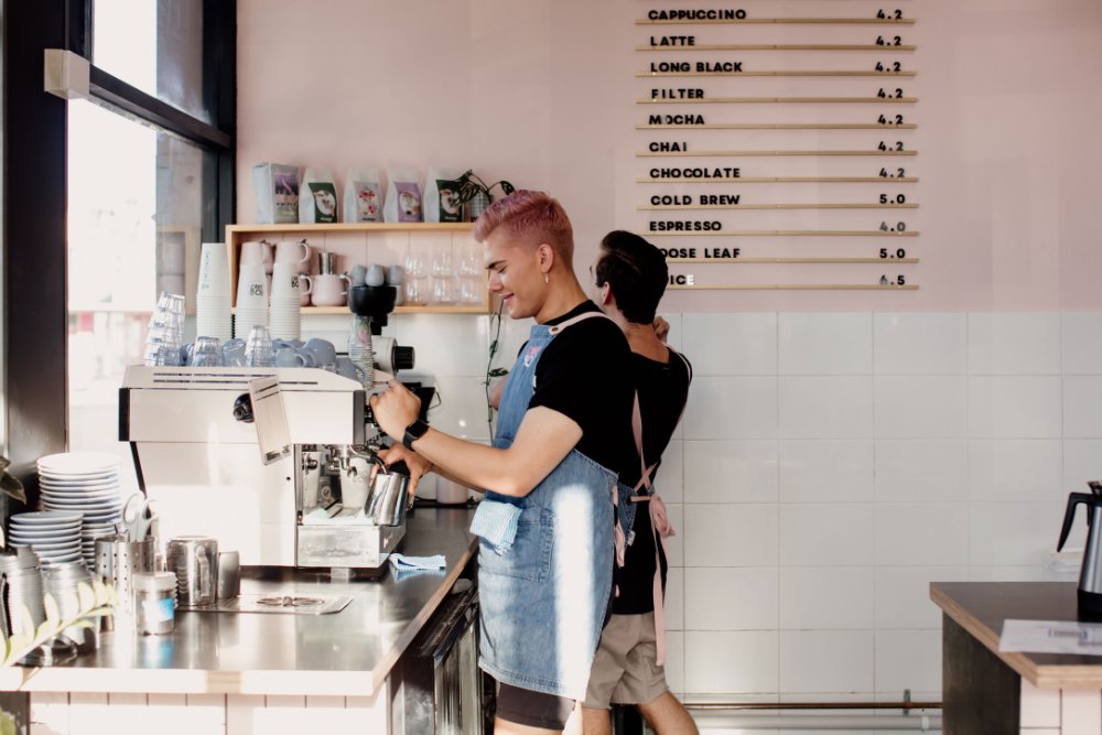 A barista making coffe at Cake Boi cafe