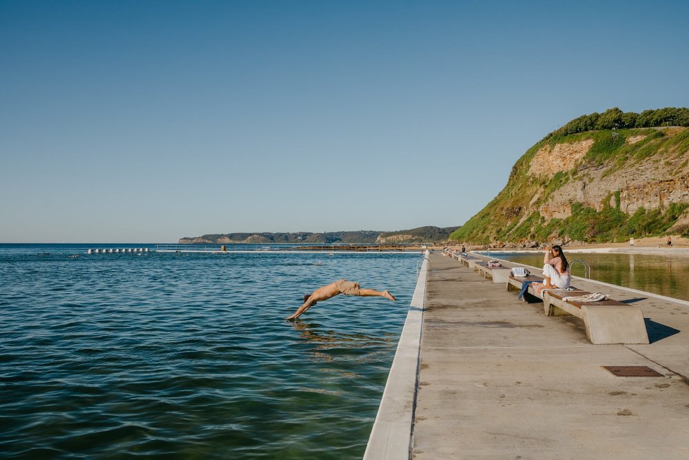 A lady diving into the water at Merewether Ocean Baths