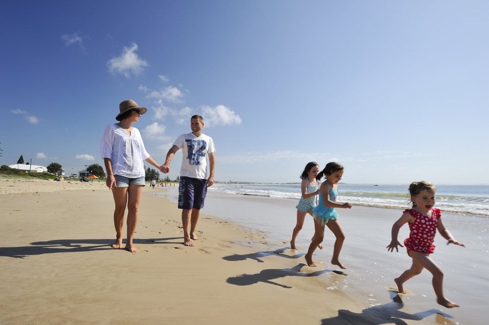 Family walking along the beach at Stockton