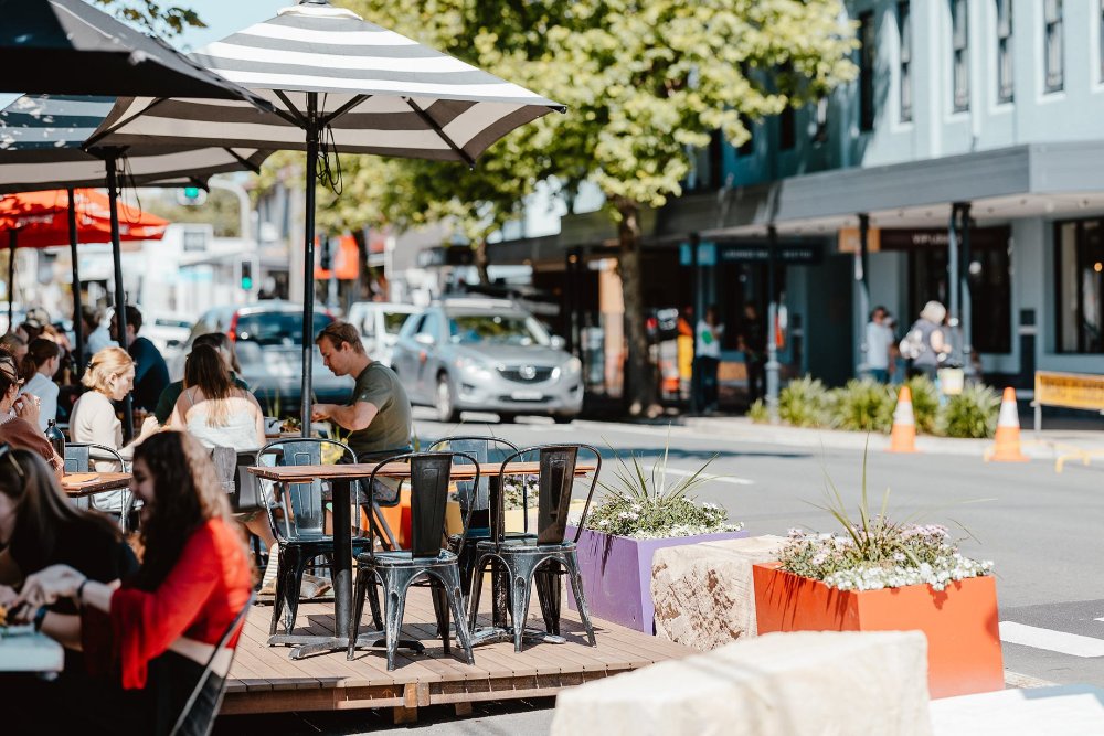 People dining on the elevated outdoor dining deck on Darby Street