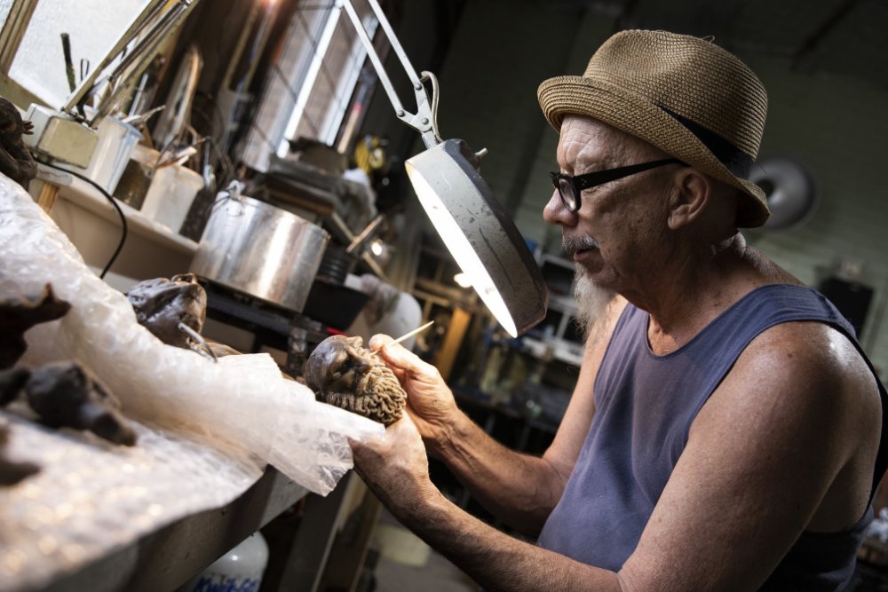 An older man sculpting at the Creator Studio