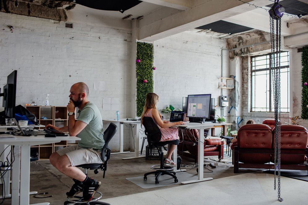 Two people work in an industrial modern co working office