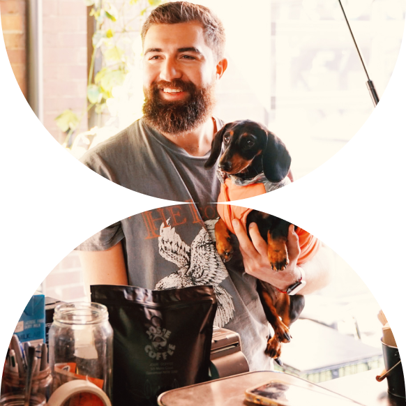 A man ordering a coffee with his dog