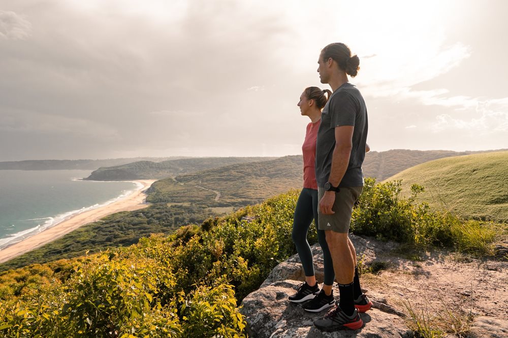 A couple admiring the ocean on a hike in Glenrock Reserve