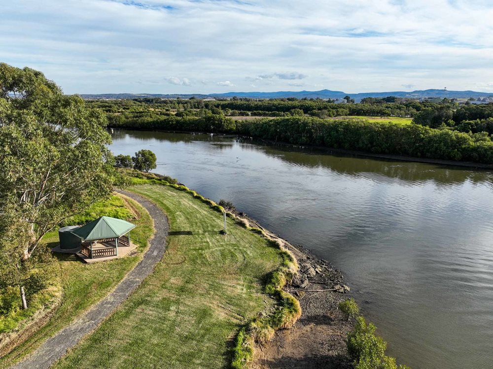 Aerial view of a shelter next to a river at Hunter Wetlands