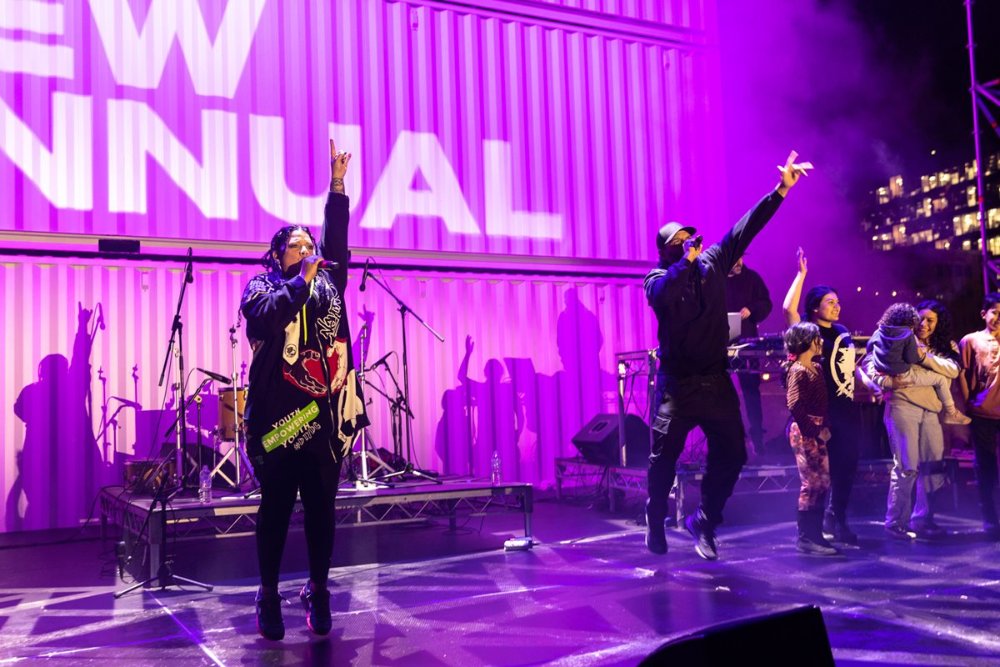 Performers on a purple stage at This Land performance as part of New Annual 2022