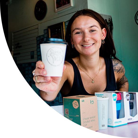 A woman handing over a coffee