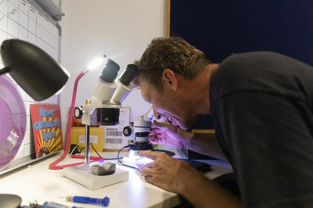 A man looks into a microscope