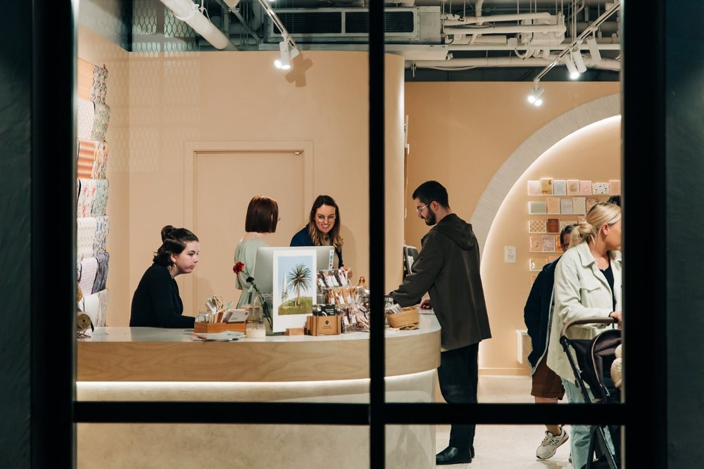 A small retail business serving a customer over the counter