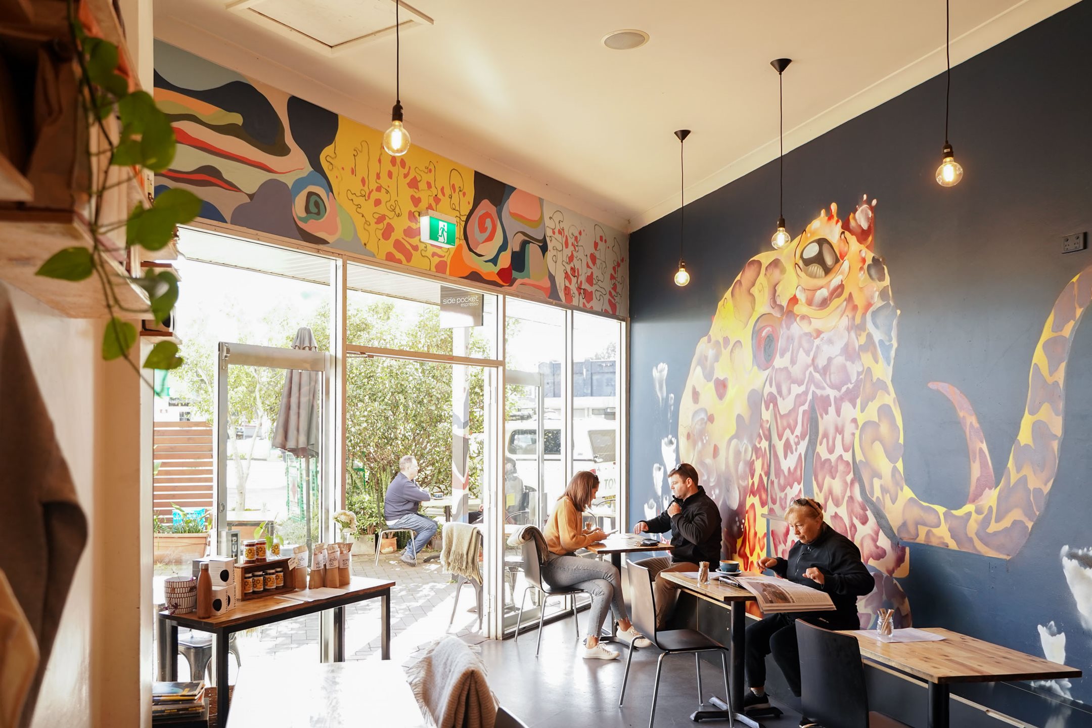 People sitting in a cafe with art on the walls