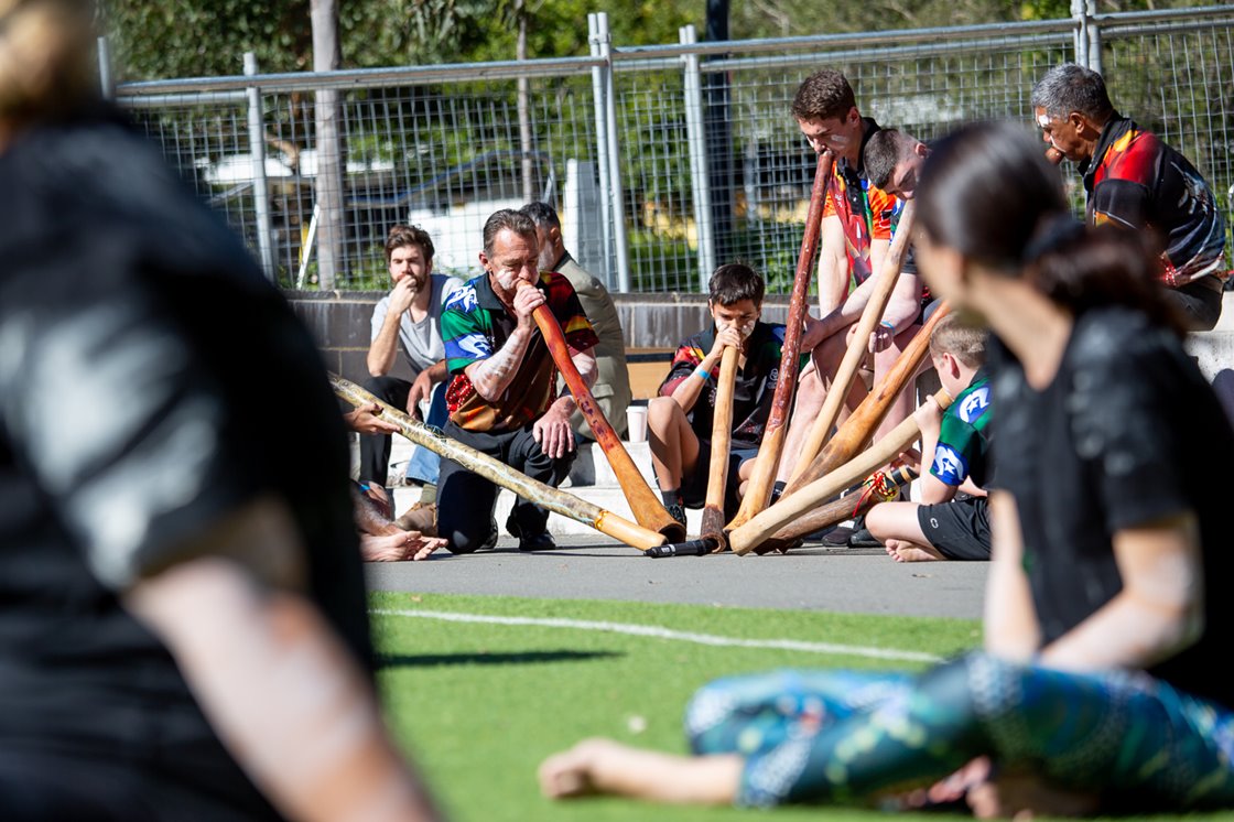 Men playing the didgeridoo at a cultural ceremony