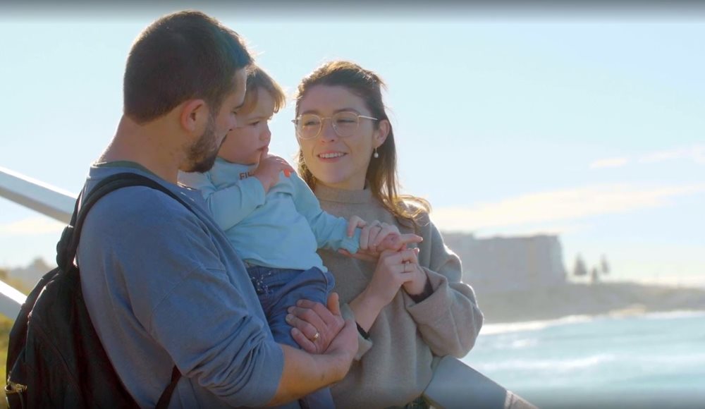 A family with their small child at a beach lookout