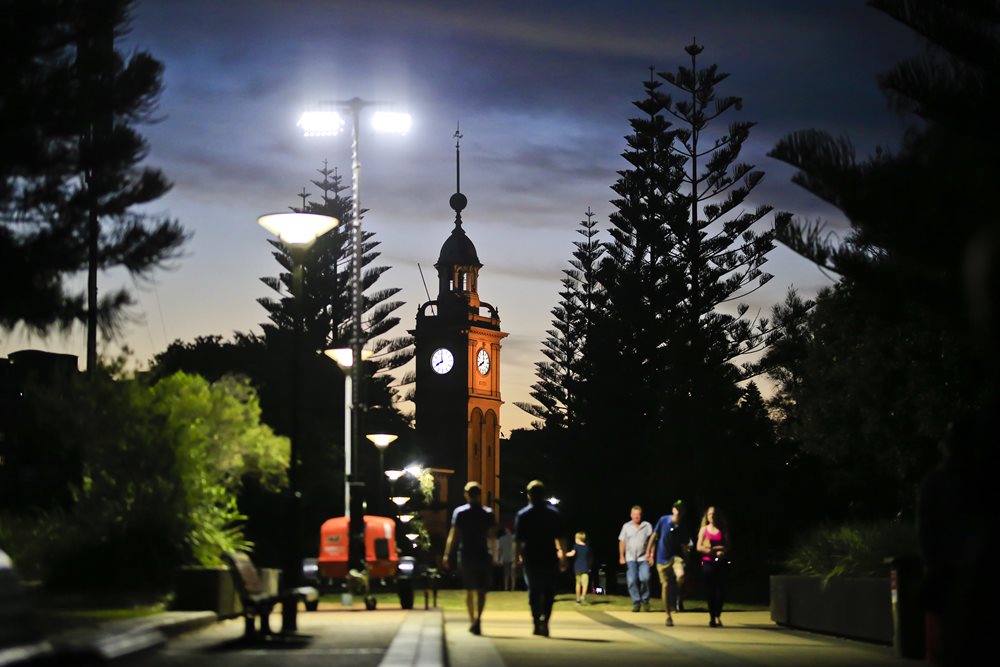 People walking towards a clock tower in Newcastle East