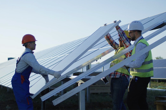 Three men installing solar panels