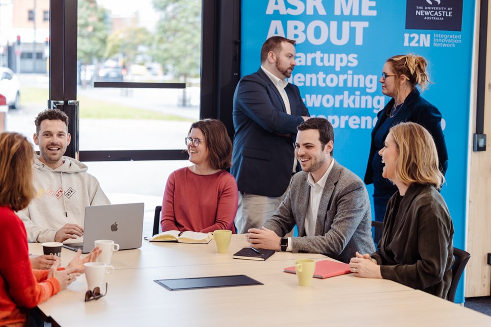 People collaborating at a desk at the Landing Pad