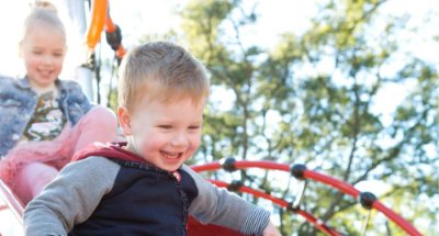 A kid sliding down a slide